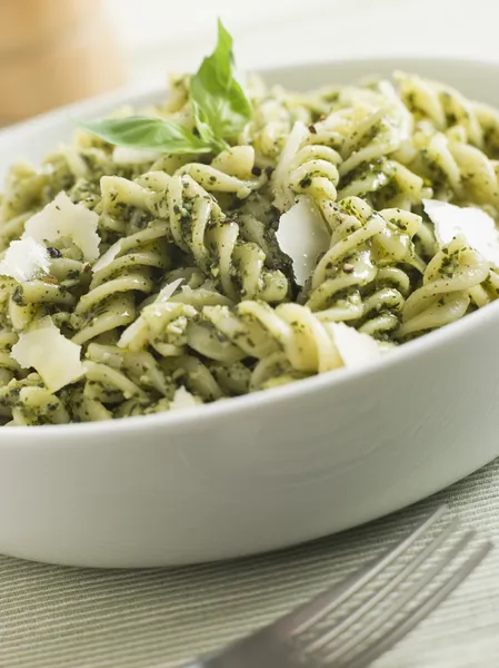 Bowl of Fusilli Pasta dressed in Pesto with Parmesan Shaves — Stock Image Bowl of Fusilli Pasta dressed in Pesto with Parmesan Shaves Royalty Free Stock Photos