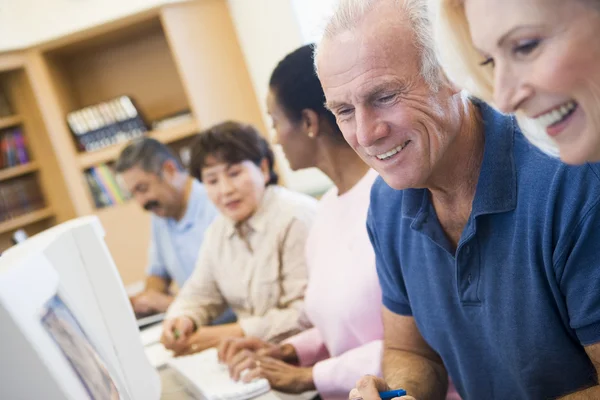 Mature students learning computer skills Stock Image