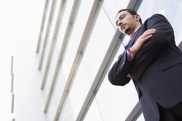Businessman standing outside modern office — Stock Photo, Image