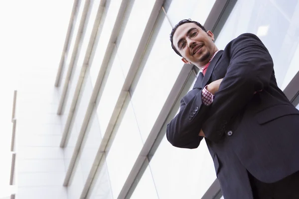 Businessman standing outside office building — Stock Photo, Image