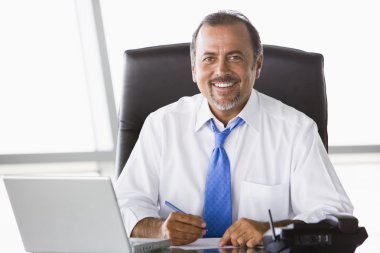 Businessman working hard at desk clipart