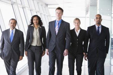 Group of business walking towards camera clipart
