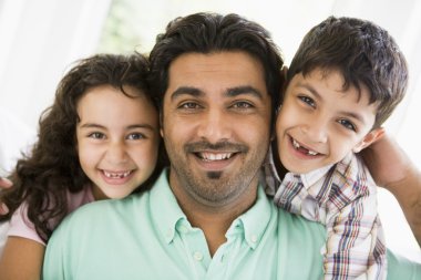 A Middle Eastern man with his children clipart