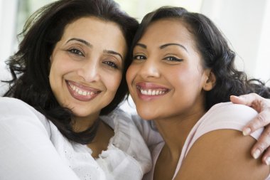 A Middle Eastern woman with her daughter-in-law clipart