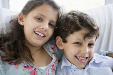 Portrait of two Middle Eastern children at home clipart