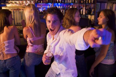 Young man in nightclub showing off for the camera clipart