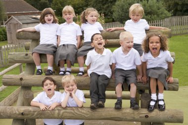 Young children sitting on benches and yelling clipart