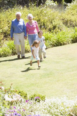 Grandparents walking with grandchildren clipart