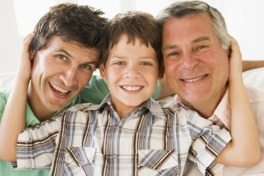 Grandfather with son and grandson smiling clipart