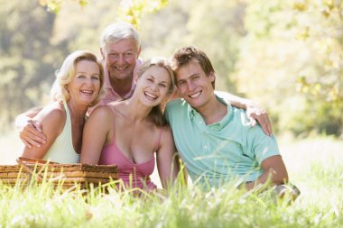 Parents with adult children on picnic clipart