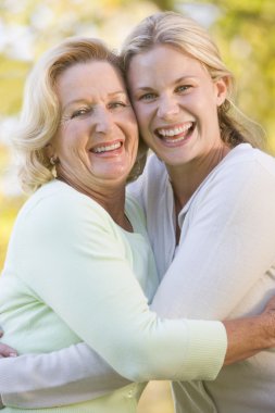 Mother hugging grown up daughter clipart