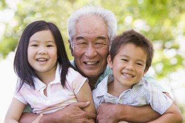 Grandfather posing with grandchildren clipart