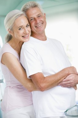 Couple embracing at a spa and smiling clipart