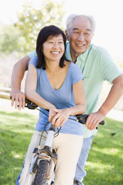 Mature couple bike riding clipart