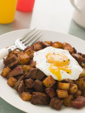 Corned Beef Hash with a Broken Fried Egg and Black Pepper clipart