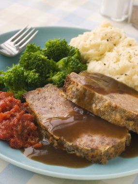 Mama's Meatloaf with Mashed Potato Broccoli Tomatoes and Gravy clipart