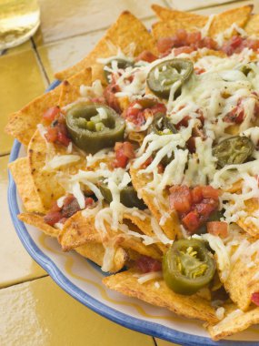 Platter of Nachos with Salsa Jalapenos and Cheese clipart