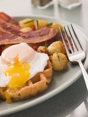 Waffles with Bacon Fried Potatoes and a Broken fried Egg clipart