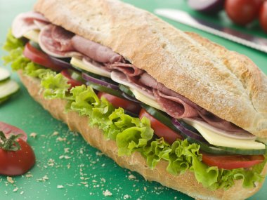 Deli Sub Sandwich on a Chopping Board clipart