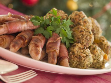 Plate of Pigs in Blankets and Chestnut Stuffing Balls clipart