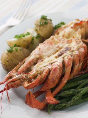 Half a Lobster Thermidor with New Potatoes and Asparagus Spears clipart