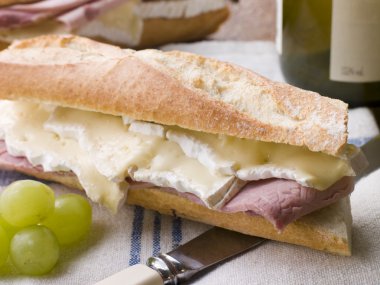 Brie and Ham Baguette with White Wine and Grapes clipart