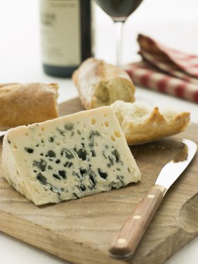 Wedge of Roquefort Cheese with Rustic Baguette and Red Wine clipart