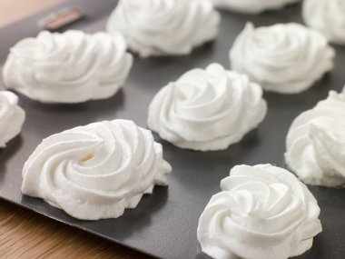 Tray of piped Meringues clipart