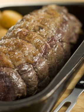 Roast Topside of British Beef in a Tray with Roast Potatoes clipart
