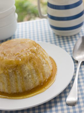 Steamed Syrup Sponge with a jug of Custard clipart