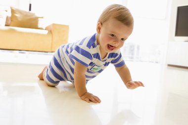 Baby crawling in living room clipart