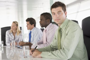 Four businesspeople in a boardroom clipart