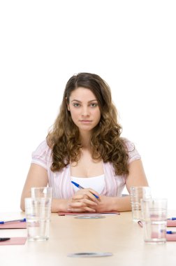 Businesswoman sitting in boardroom clipart