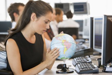Businesswoman in office space with desk globe clipart