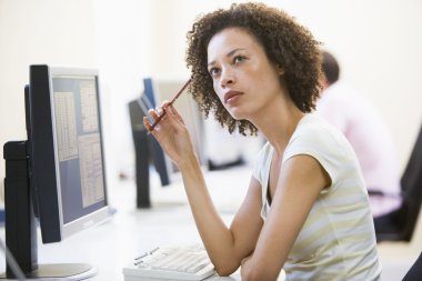 Woman in computer room thinking clipart