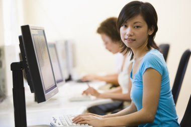 Two women in computer room clipart