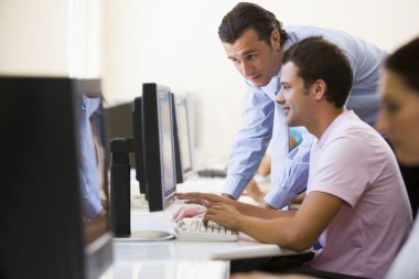 Man assisting other man in computer room clipart