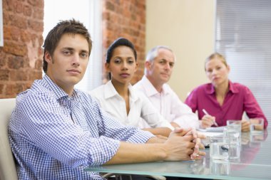 Four businesspeople in boardroom clipart