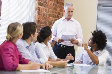 Five businesspeople in boardroom meeting clipart