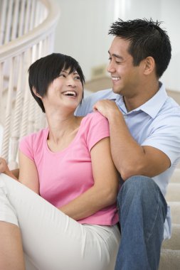 Couple sitting on staircase smiling clipart