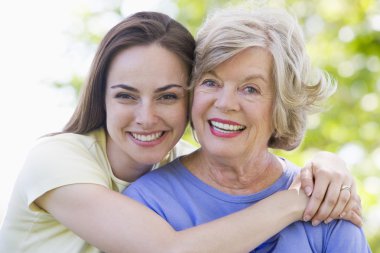 Two women outdoors smiling clipart