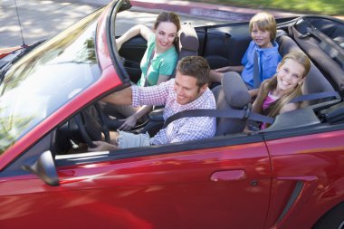 Family in convertible car smiling clipart