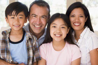 Family in living room smiling clipart