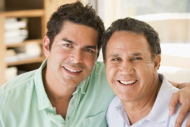 Two men in living room smiling clipart