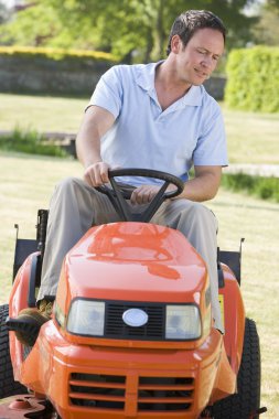 Man outdoors driving lawnmower clipart