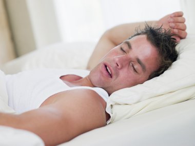 Man lying in bed sleeping clipart