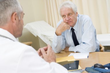 Man in doctor's office frowning clipart