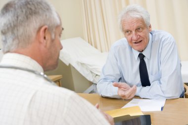 Man in doctor's office smiling clipart