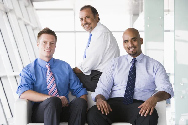 Group of businessmen sitting in lobby — Stock Photo, Image