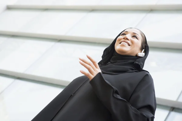 Eine Geschäftsfrau aus dem Nahen Osten steht vor einem Büroblock — Stockfoto